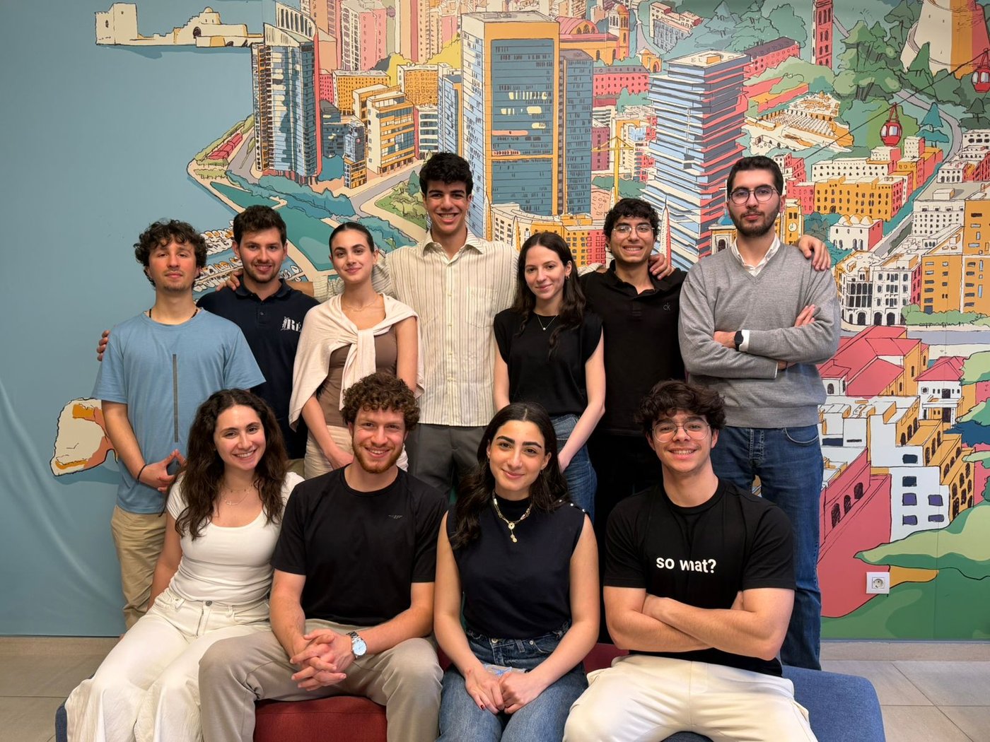 The Phoenix Institute team in front of an illustrated mural of Beirut
