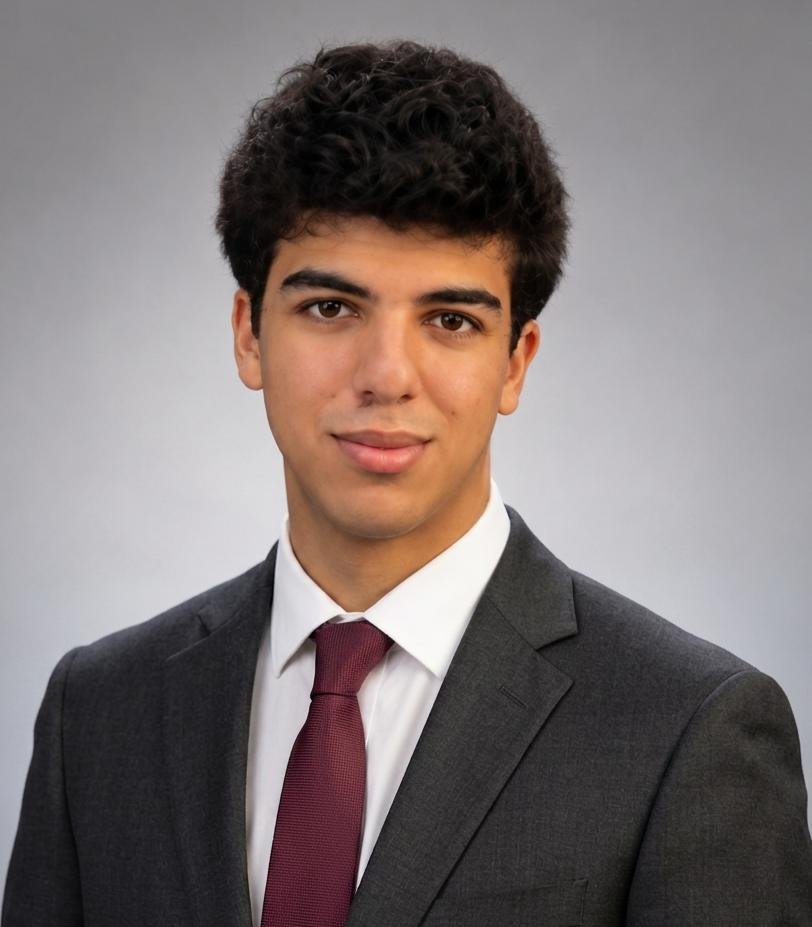 Portrait of Samir Kassir in a gray suit and oxblood tie